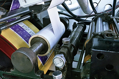 Adhesive layer and reverse printing unit